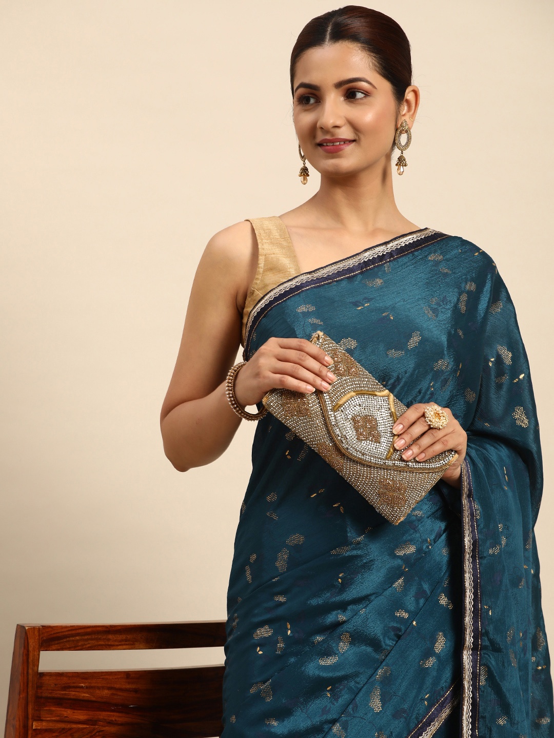 

Indian Women Teal & Gold-Toned Embellished Designer Saree