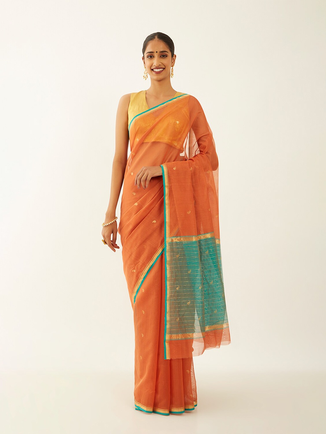 

Taneira Orange & Green Ethnic Motifs Woven Design Zari Silk Cotton Chanderi Saree