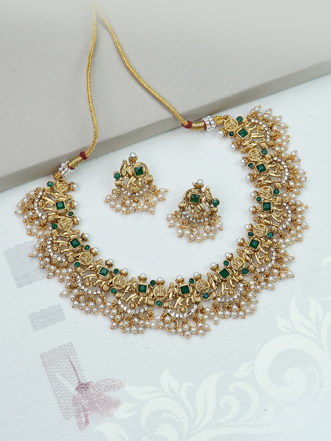 

Diksha collection Gold-Plated Stone-Studded & Beaded Matte Finish Jewellery Set