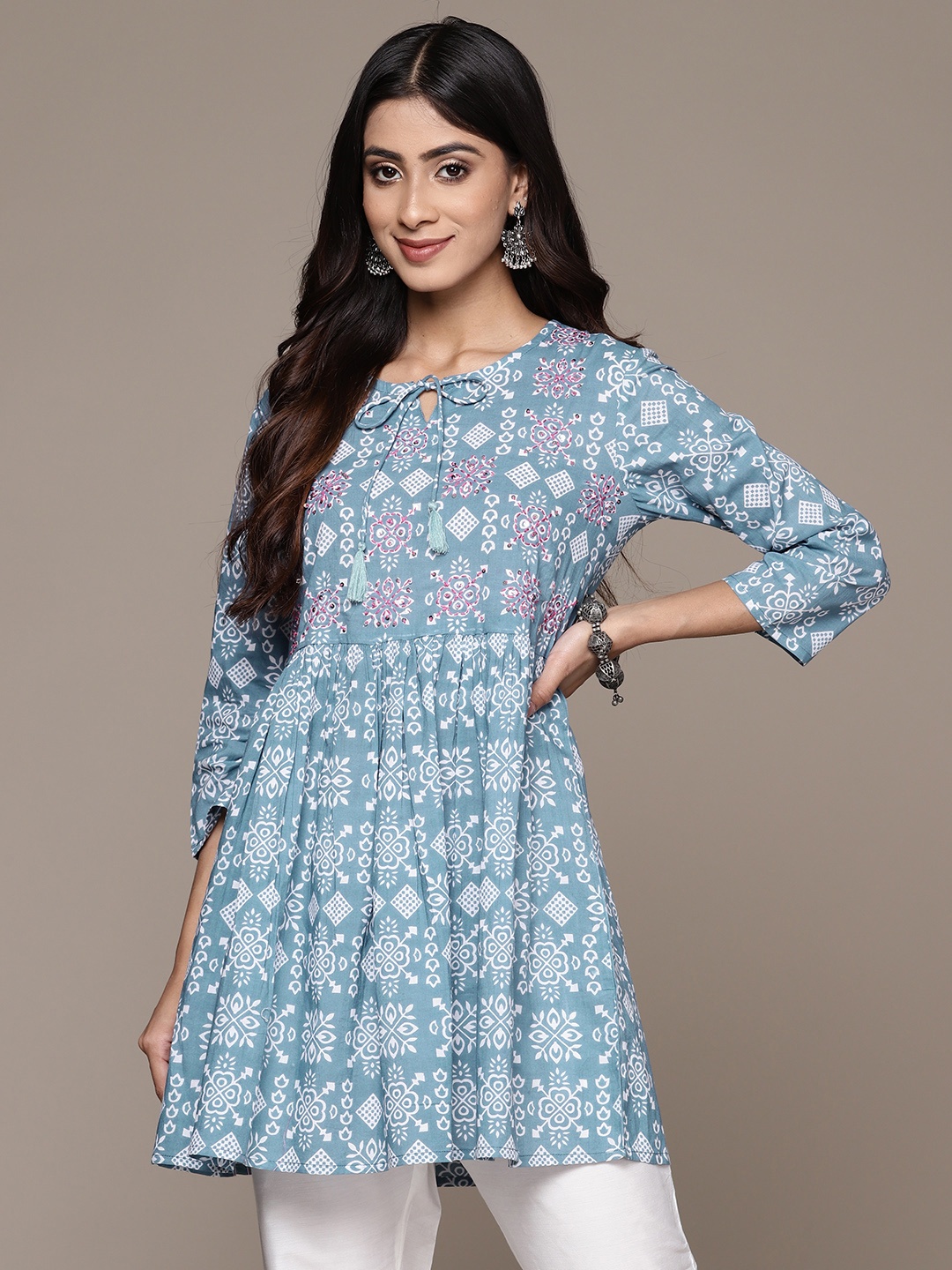 

Anubhutee Geometric Printed Tie-Up Neck Pure Cotton Sequinned Pleated Kurti, Blue