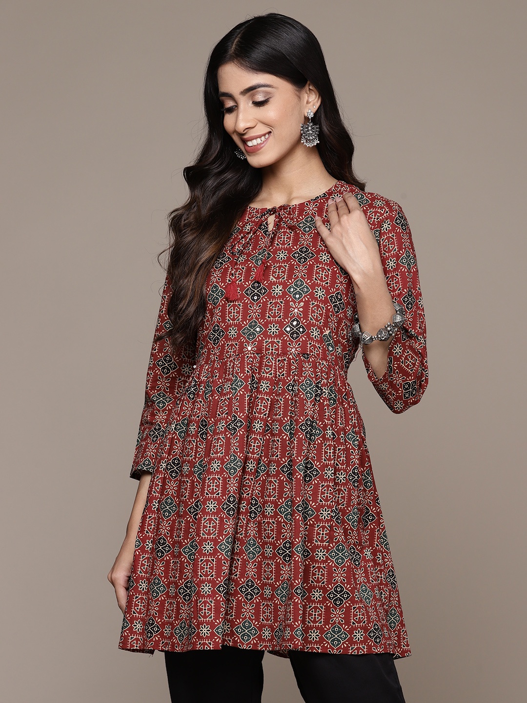 

Anubhutee Ethnic Motifs Printed Tie-Up Neck Pure Cotton Sequinned Pleated Kurti, Maroon