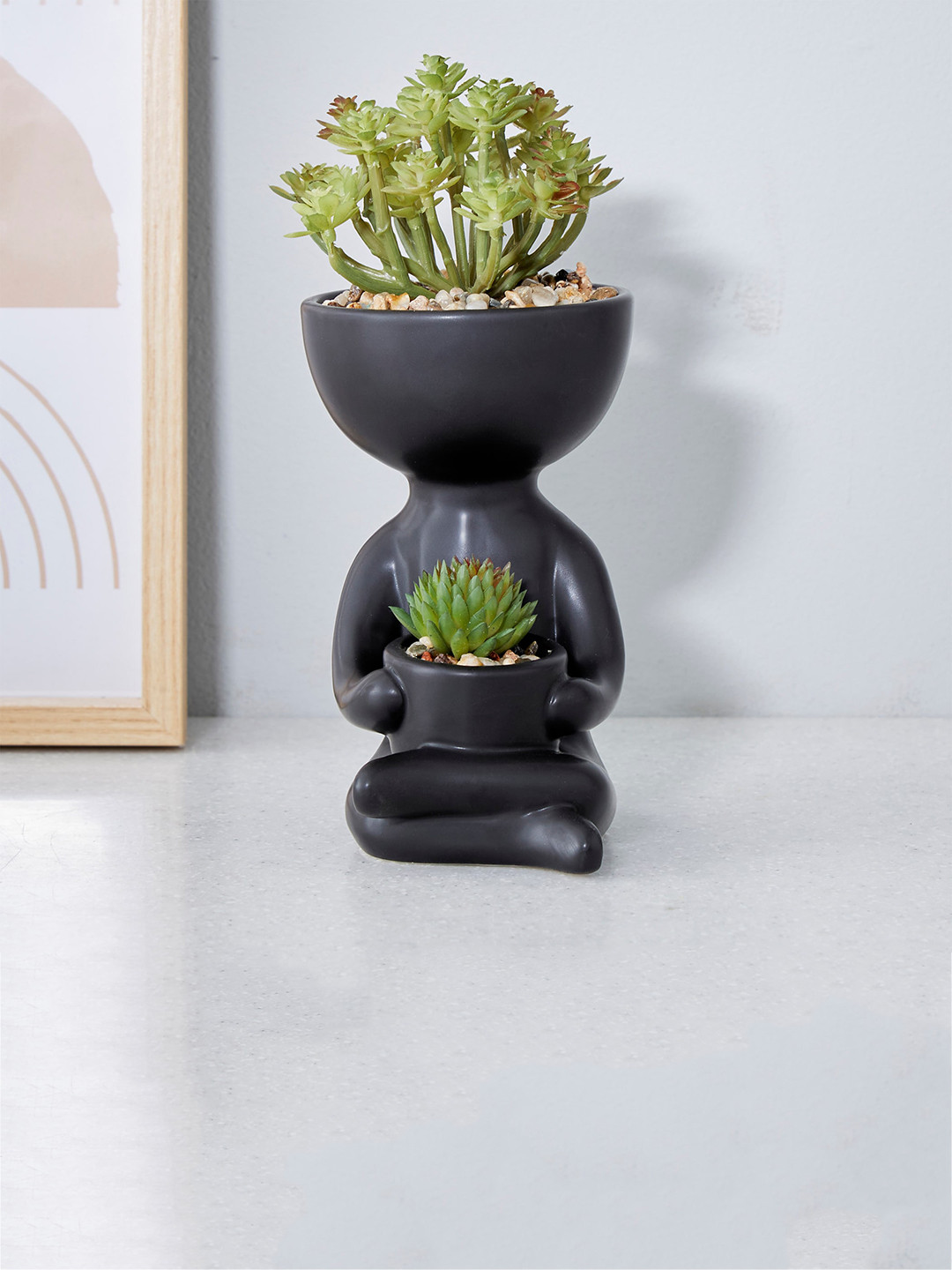

Home Centre Gloria Black Human Shaped Ceramic Planter With Artificial Plants