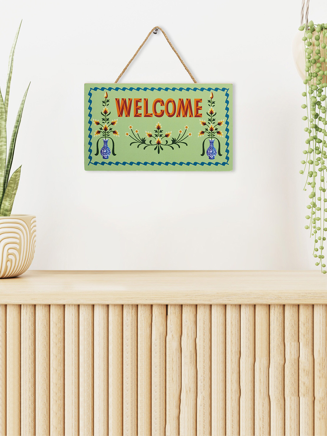 

Home Centre Garnet Interiors Green & Blue Printed Wooden Wall Hanging