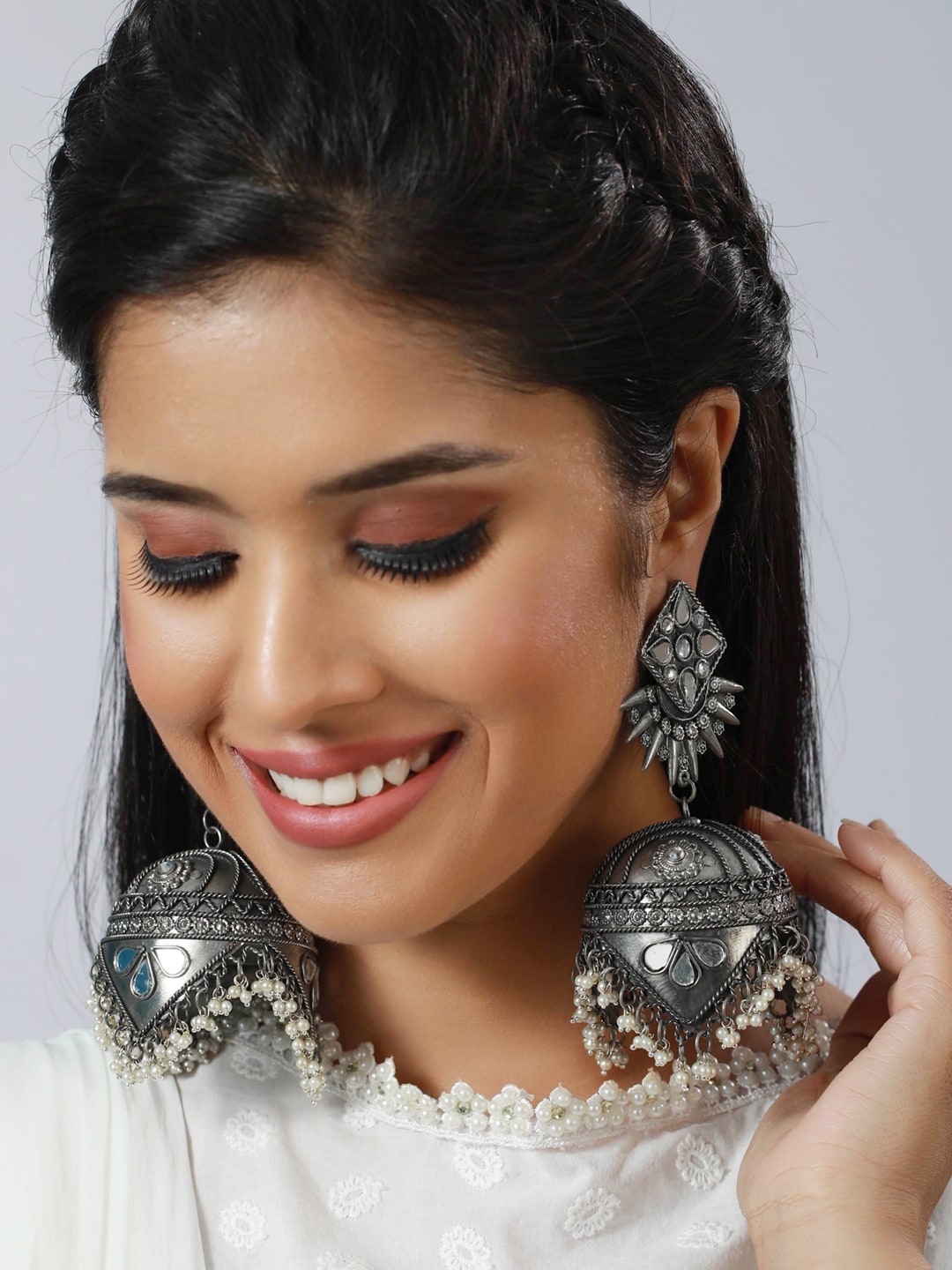 

Sangria Silver-Toned & White Silver-Plated Stone-Studded & Beaded Jhumka Earrings