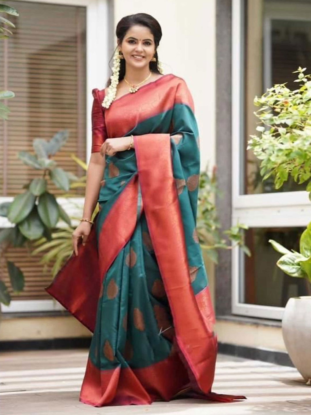 

Mitera Teal & Red Ethnic Motif Woven Design Zari Saree