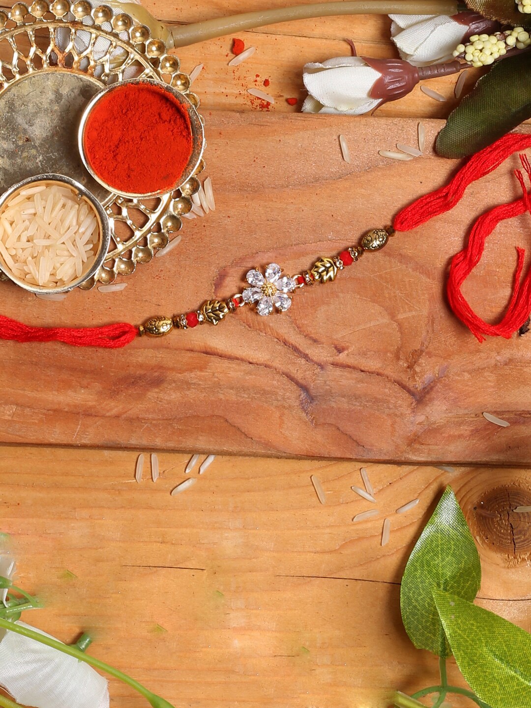 

Aapno Rajasthan Stone Studded Flower Rakhi, Gold