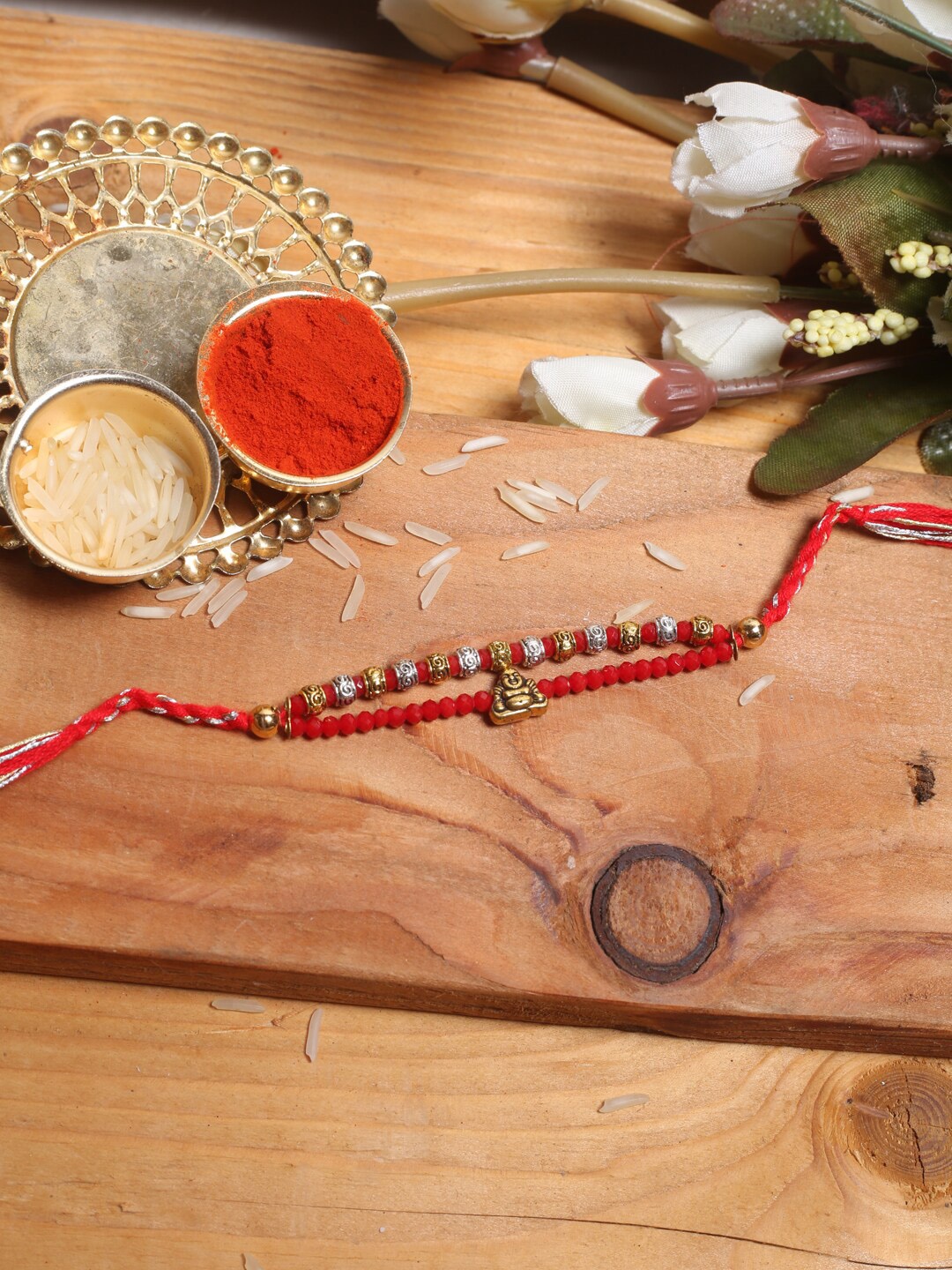 

Aapno Rajasthan Laughing Buddha Beaded Thread Rakhi With Roli Chawal, Red