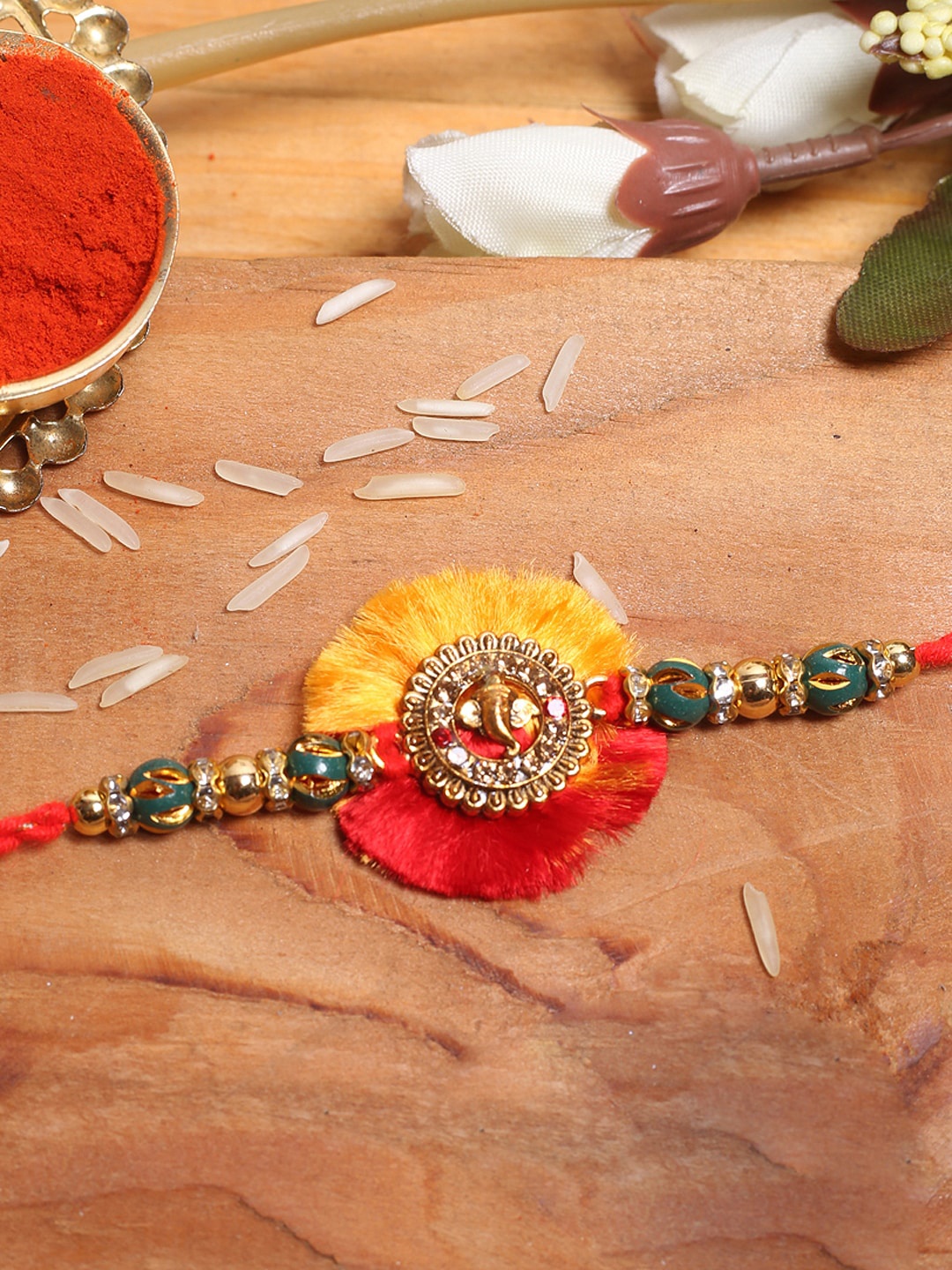 

Aapno Rajasthan Lord Ganesha Thread Rakhi With Roli Chawal, Gold