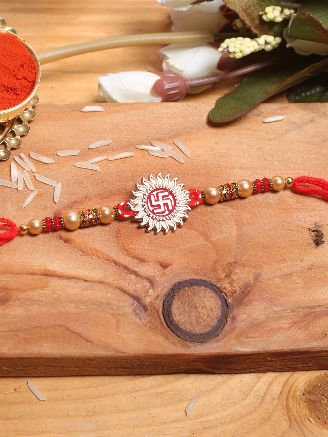 

Aapno Rajasthan Swastika Thread Rakhi With Roli Chawal, Red