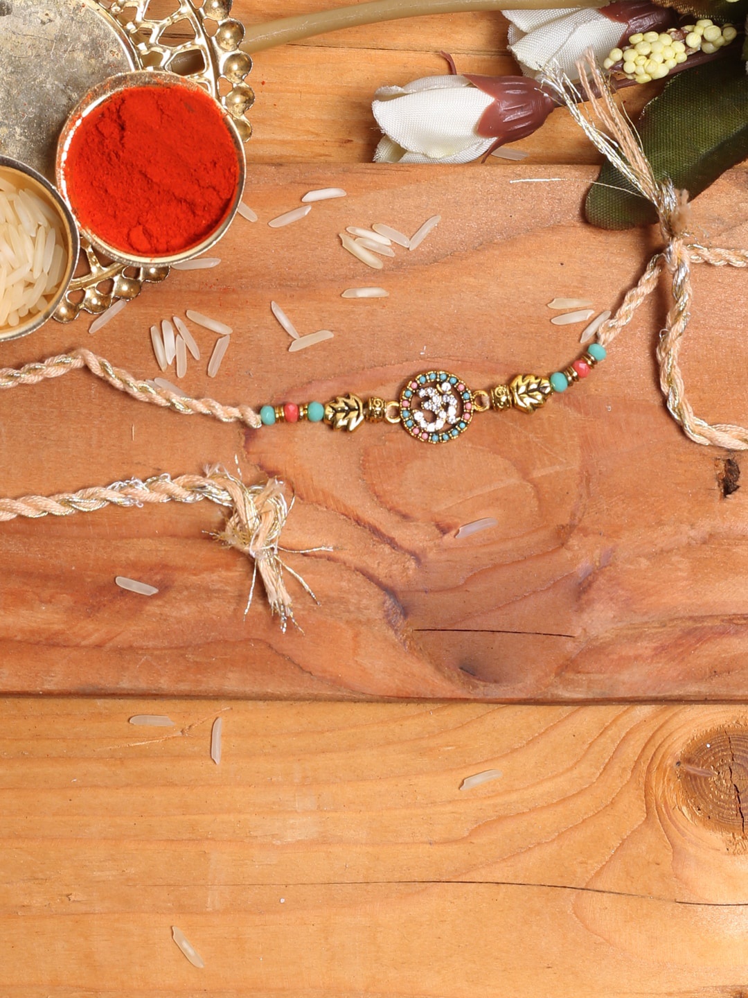 

Aapno Rajasthan OM Stone-Studded & Beaded Thread Rakhi With Roli Chawal, Blue