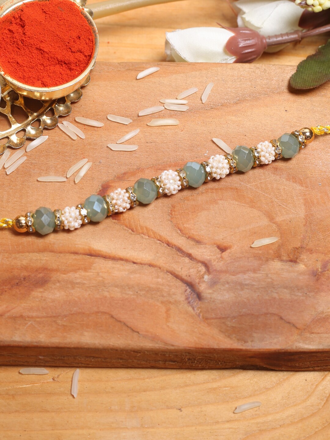 

Aapno Rajasthan Beaded Thread Rakhi With Roli Chawal, Off white