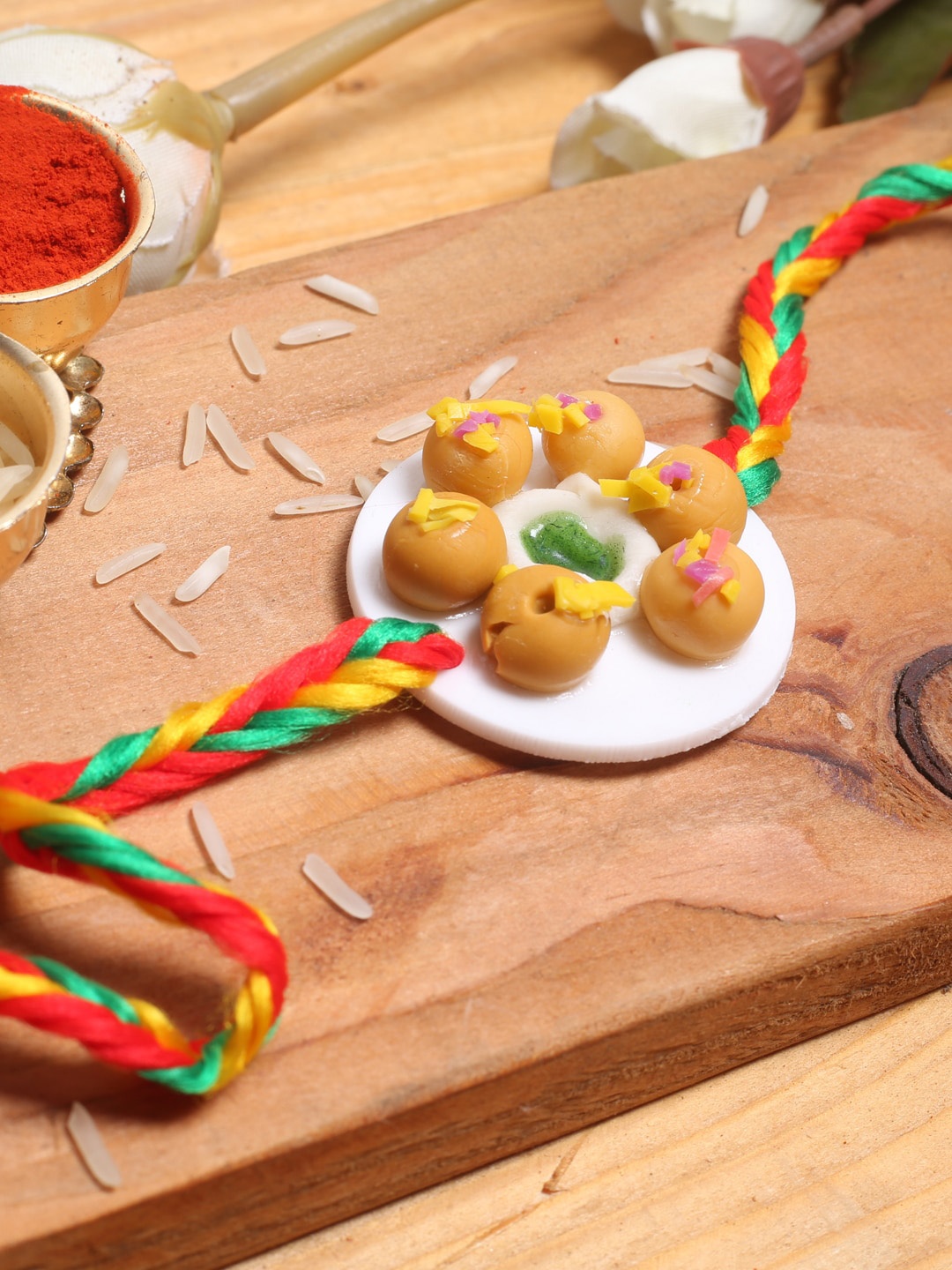 

Aapno Rajasthan Kid Sweet Dish Thread Rakhi With Roli Chawal, Red