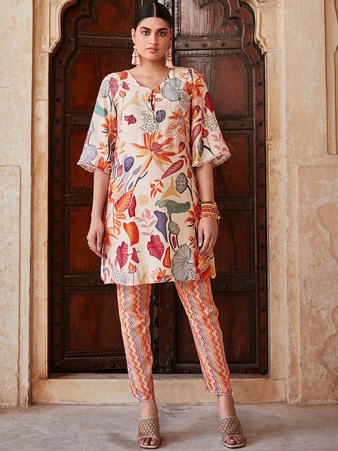 

Jaipur Kurti Beige & Orange Floral Printed Beads Work Kurti with Trousers