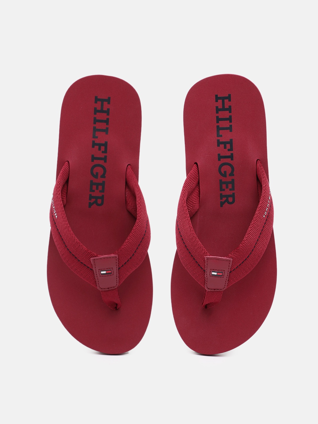 

Tommy Hilfiger Men Self Design Thong Flip-Flops With Minimal Brand Logo Print Detail, Red