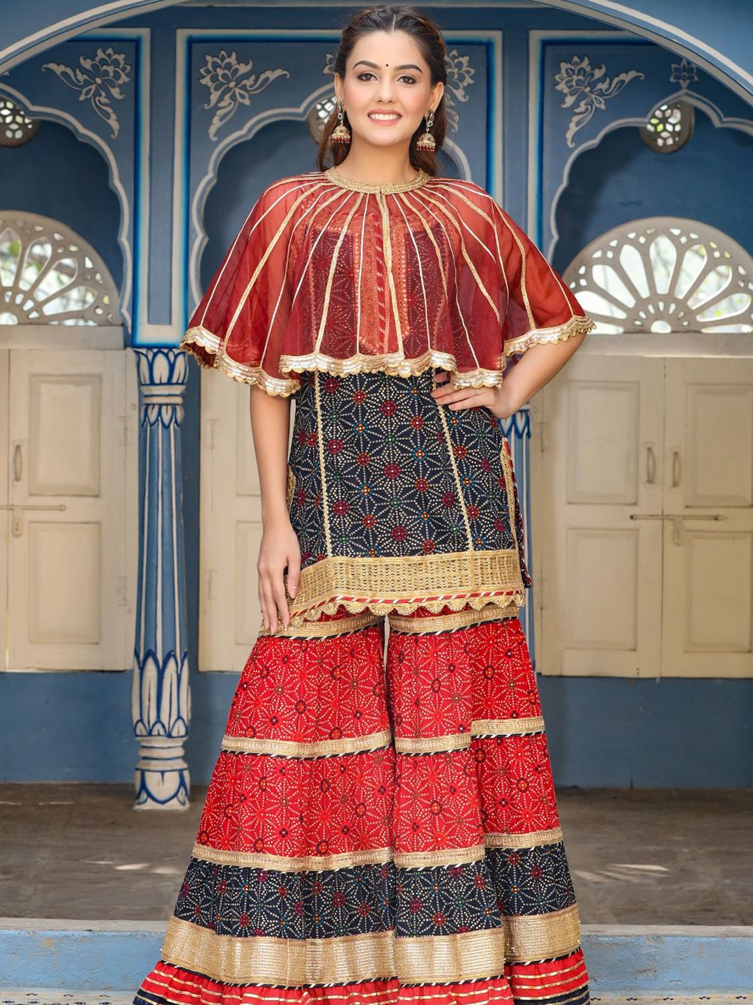 

Zolo Label Ethnic Motifs Printed Regular Gotta Patti Pure Cotton Kurti With Sharara & Cape, Red