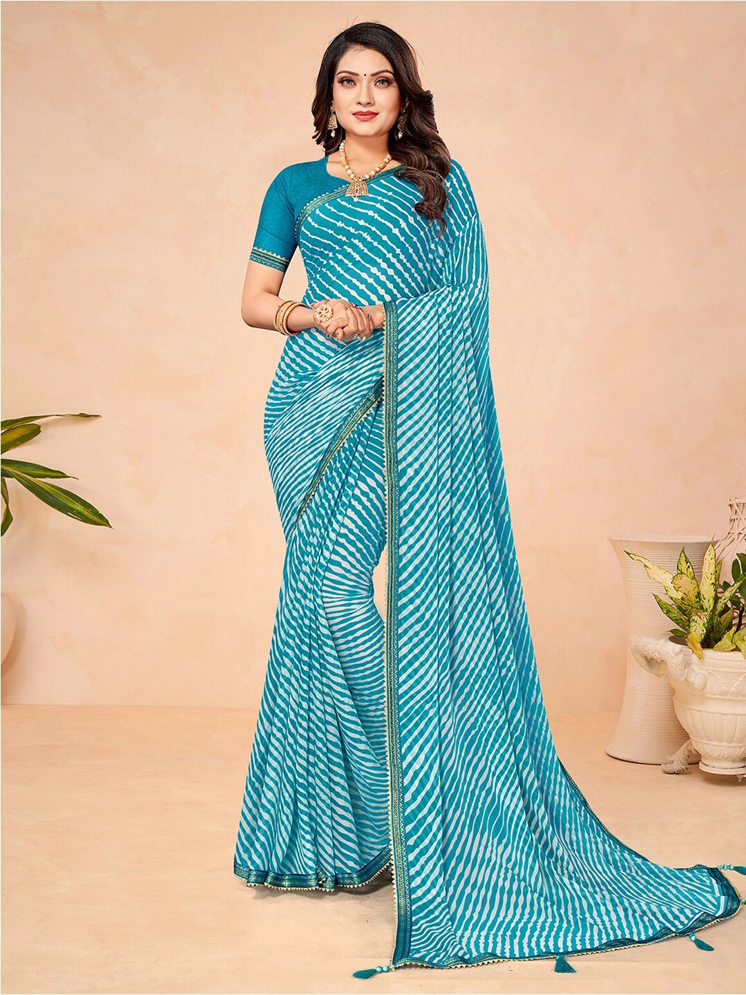 

Mitera Blue & White Leheriya Printed Zari Saree
