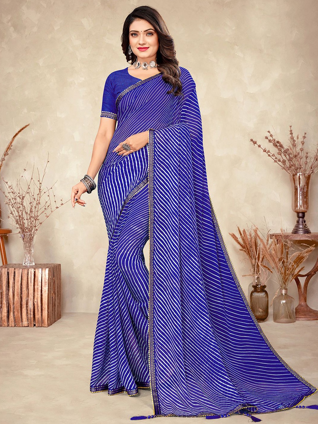 

Mitera Blue & White Leheriya Printed Zari Saree