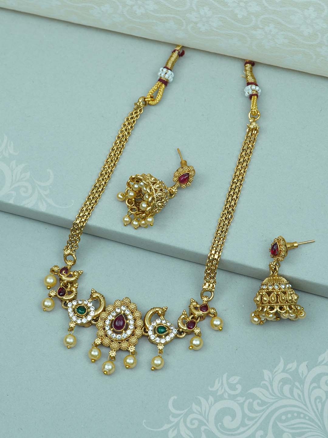 

Diksha collection Gold-Plated Stone Studded & Beaded Jewellery Set