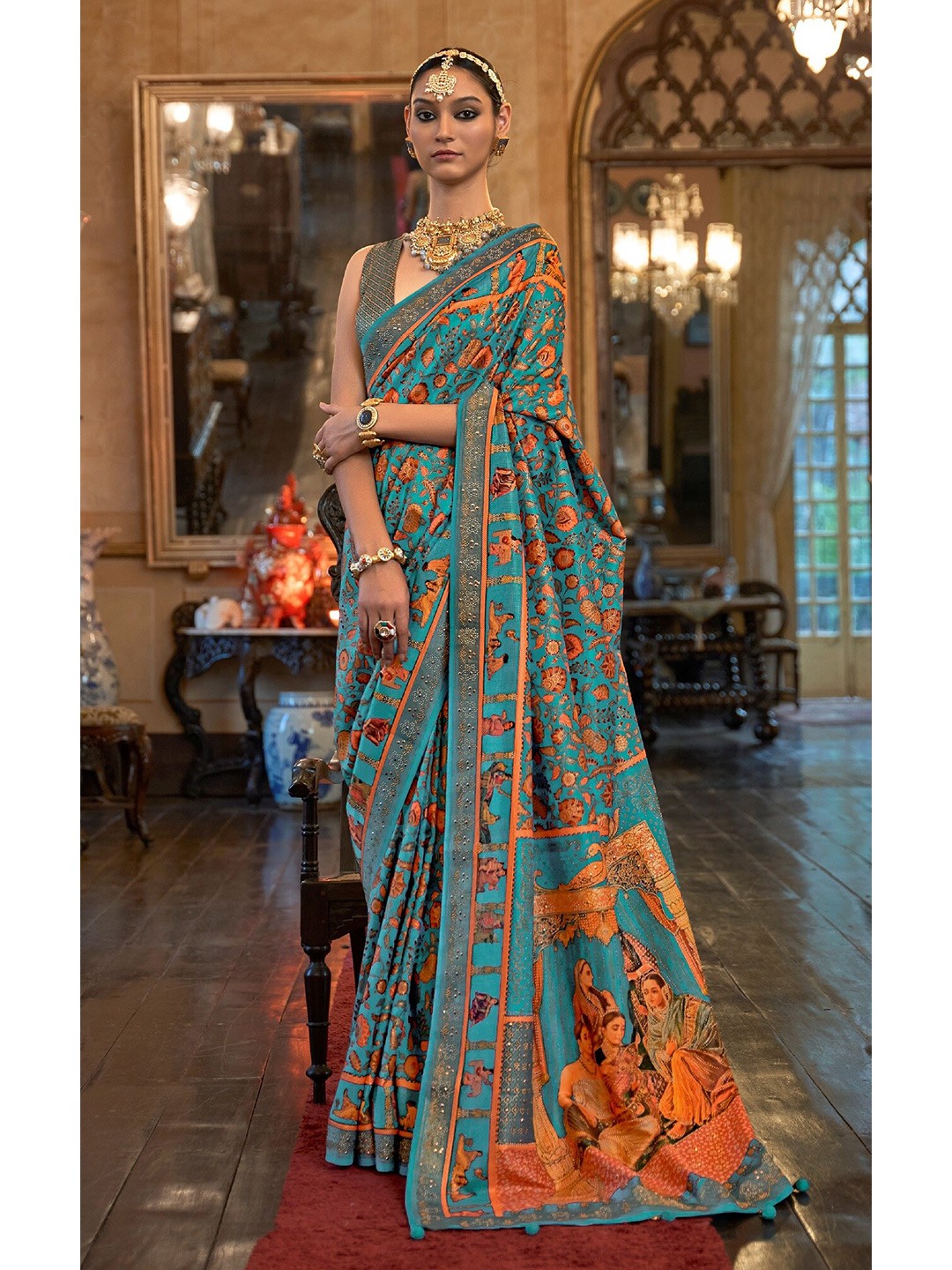 

Mitera Blue & Orange Ethnic Motifs Beads and Stones Silk Blend Patola Saree