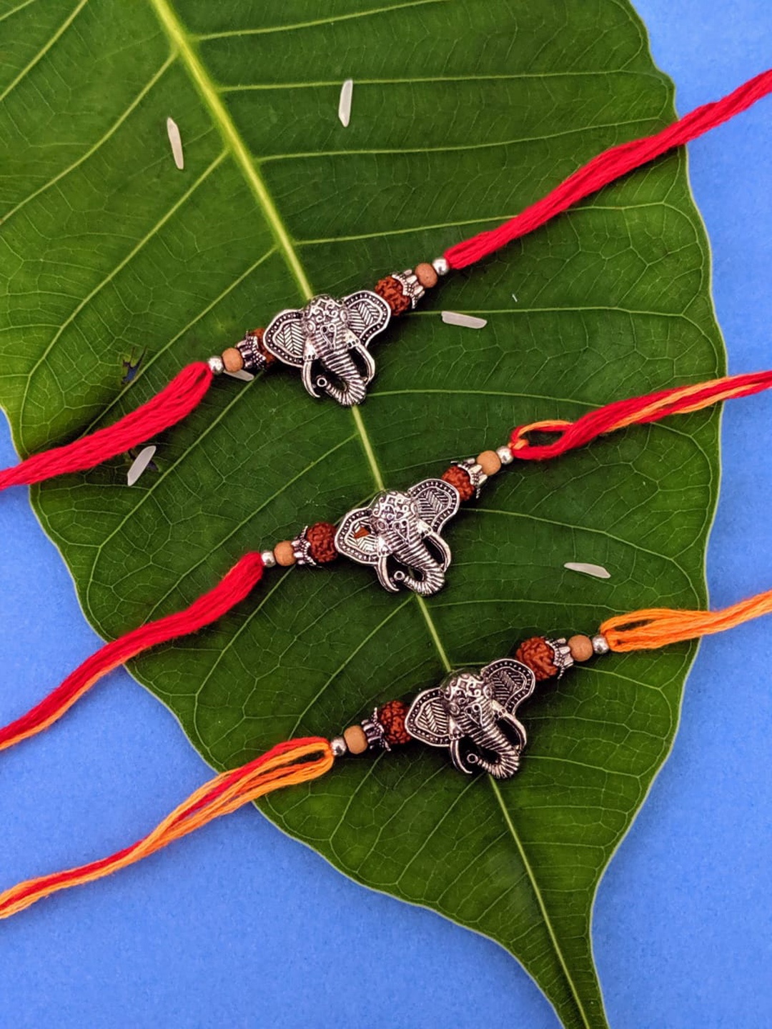 

Digital Dress Room Set of 3 Silver-Plated Ganpati Rakhi, Red
