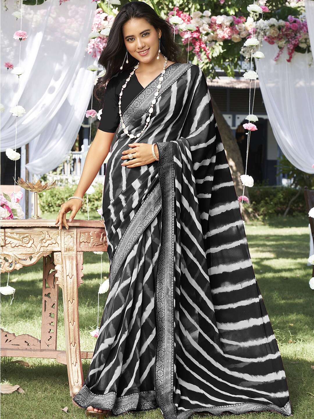 

Satrani Black & White Leheriya Striped Zari Poly Georgette Saree
