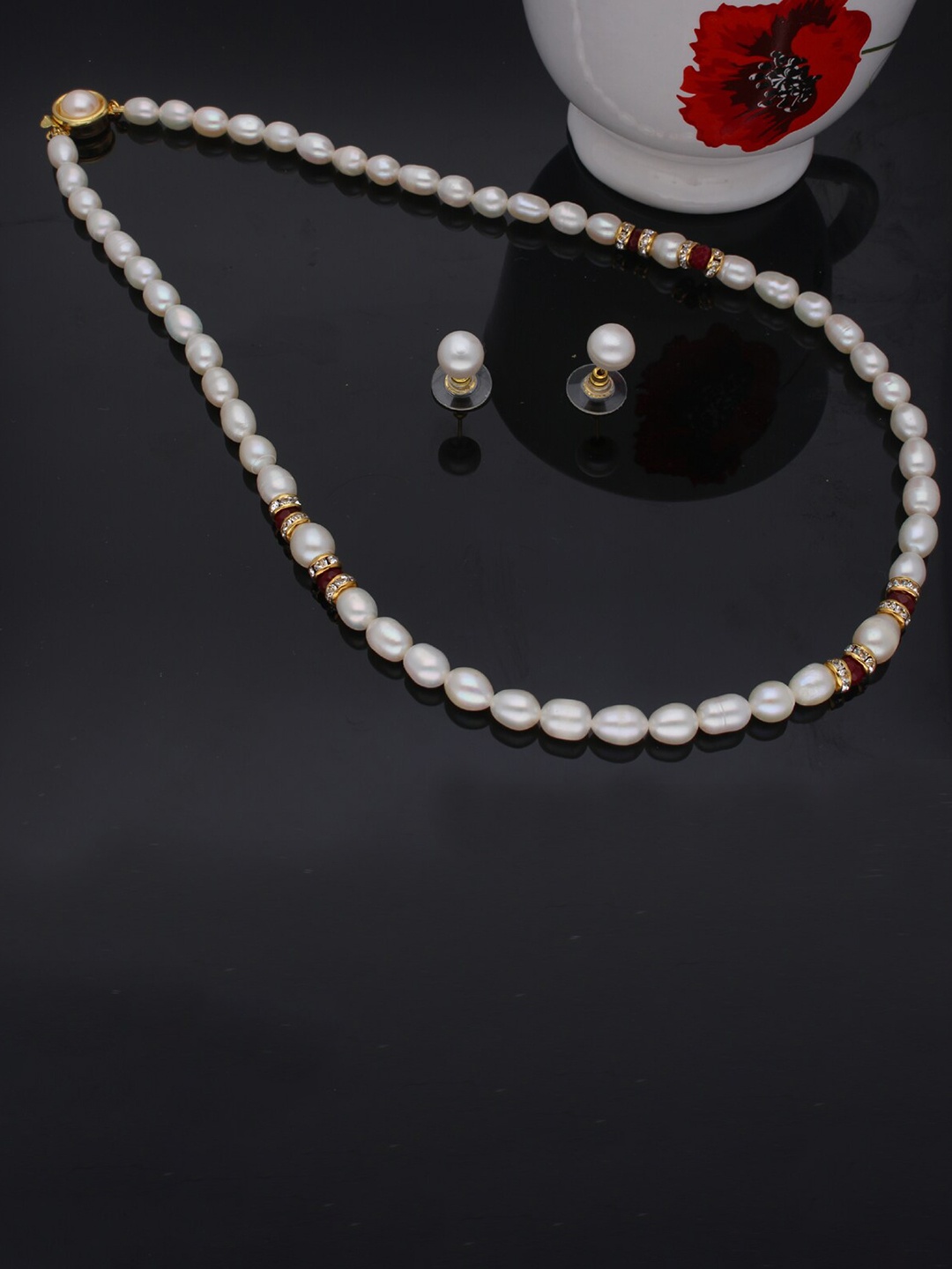 

Sri Jagdamba Pearls Dealer Gold-Plated Stone Studded & Beaded Jewellery Set