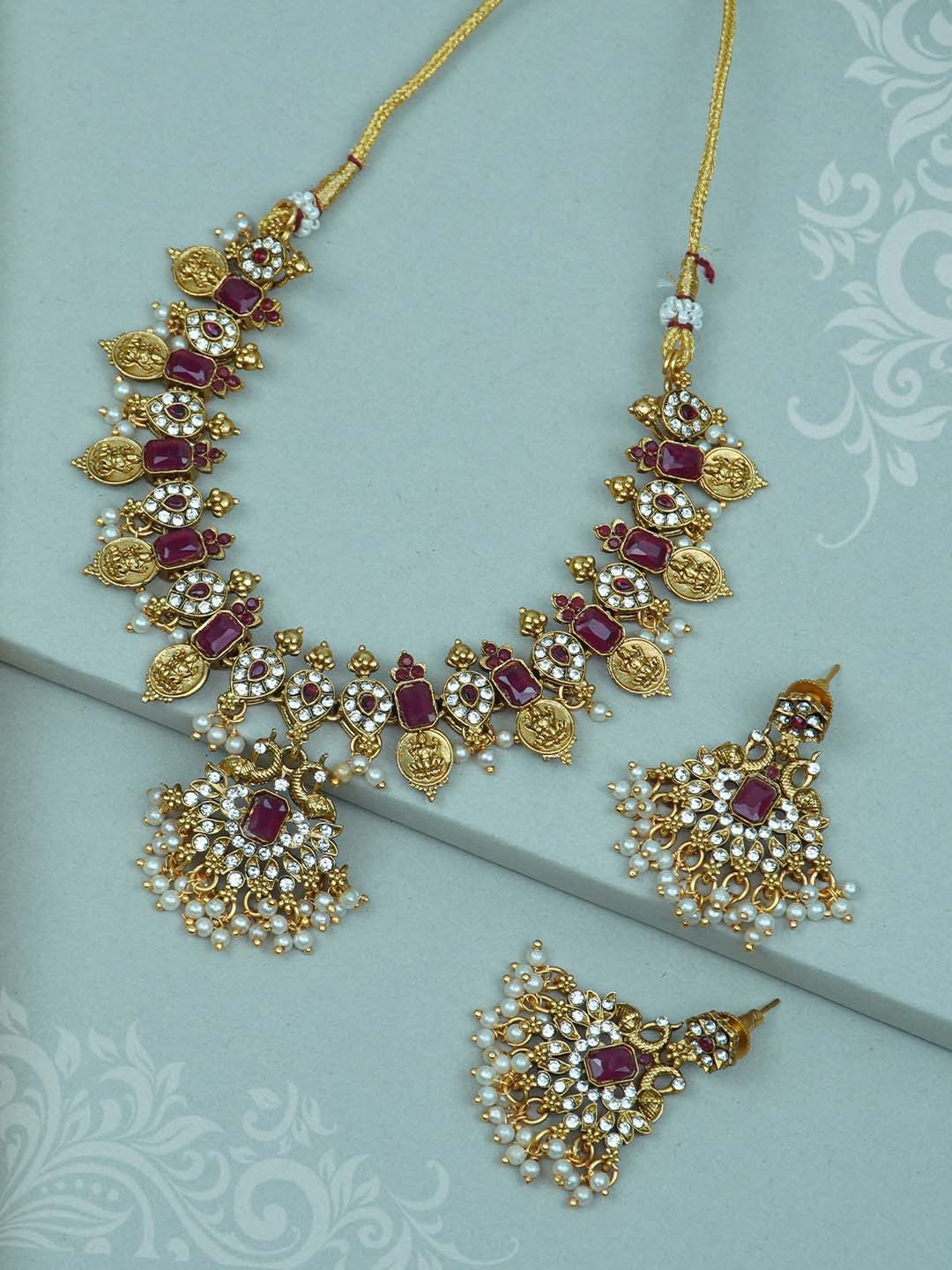 

Diksha collection Gold-Plated Stone Studded & Beaded Jewellery Set
