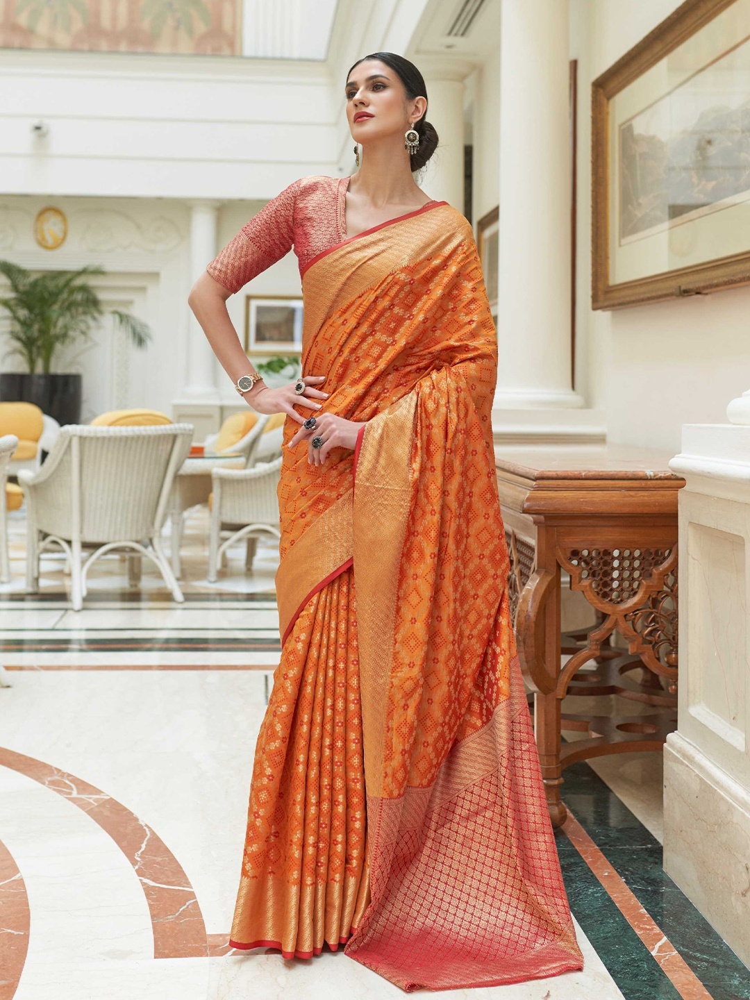 

Mitera Orange Floral Woven Design Zari Patola Saree