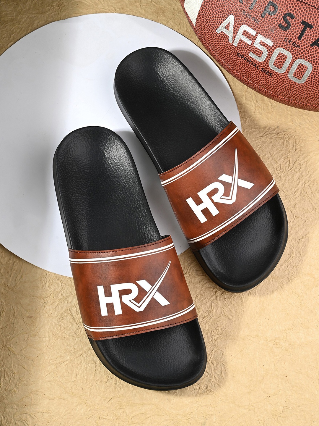 

HRX by Hrithik Roshan Men Tan & Black Brand Logo Printed Sliders