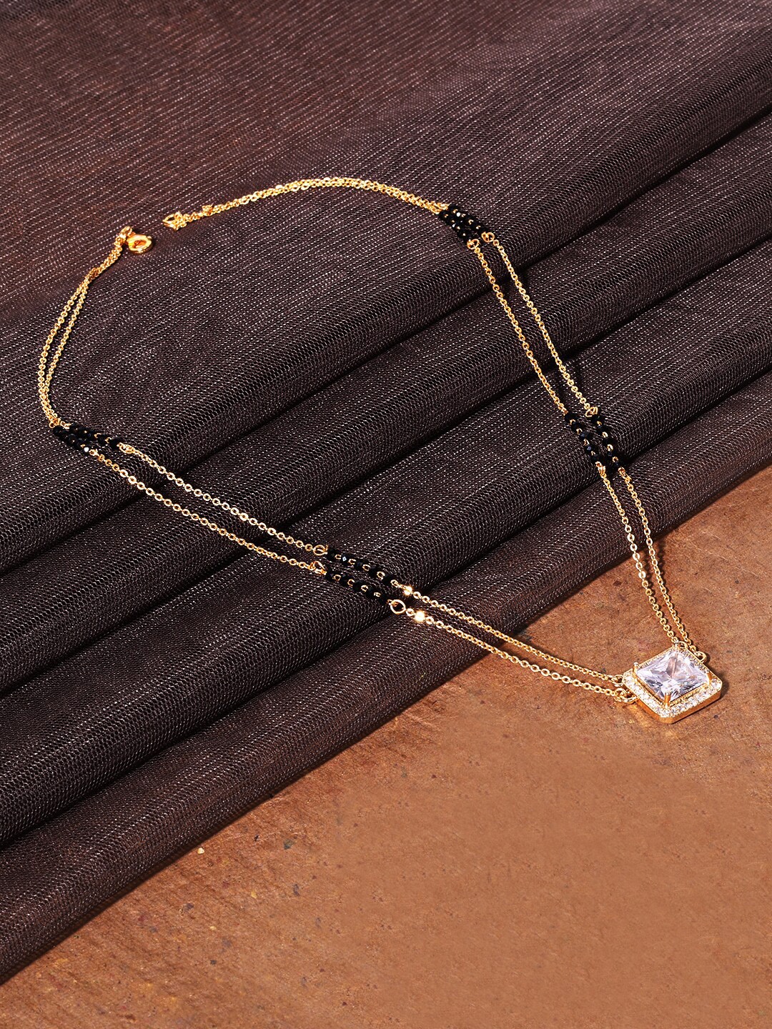 

ABDESIGNS Gold-Plated AD Stone-Studded & Black Beaded Mangalsutra