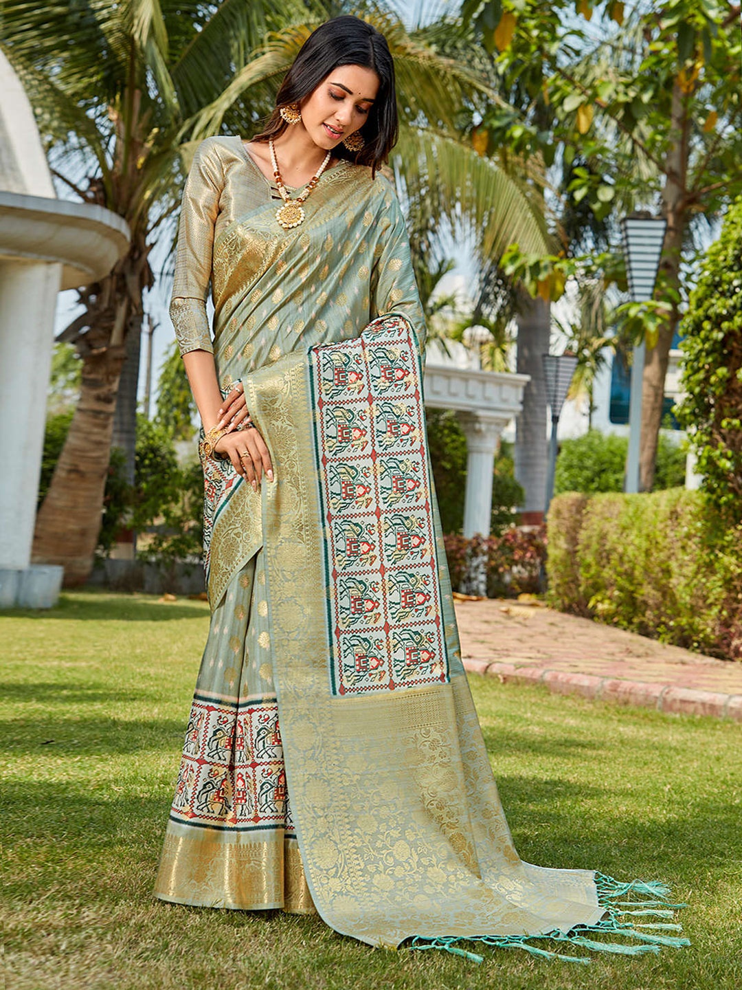 

Mitera Teal & Gold-Toned Ethnic Motifs Woven Design & Printed Zari Saree