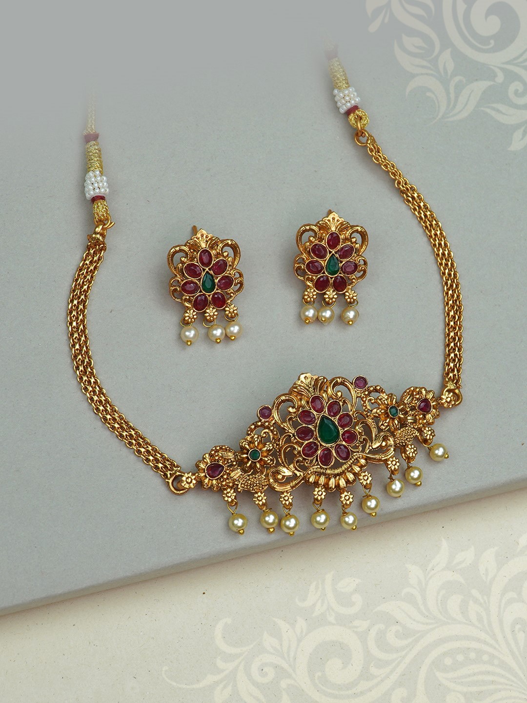 

Diksha collection Gold-Plated Stone Studded & Beaded Jewellery Set