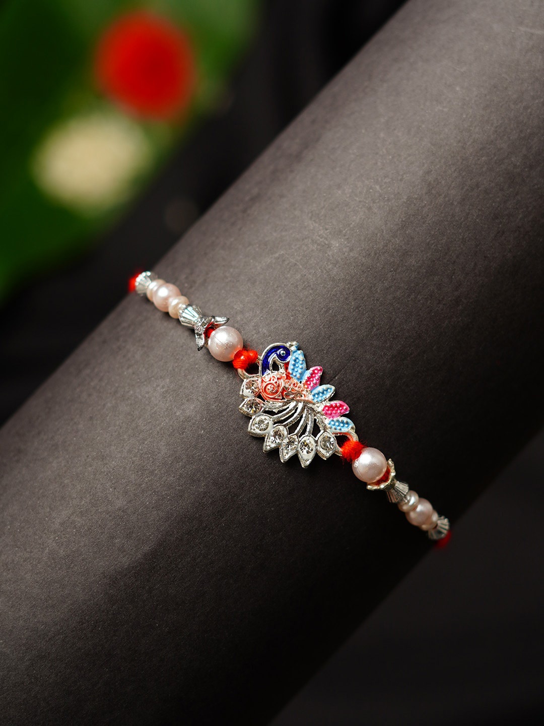 

Urmika Peacock Motif Beaded Thread Rakhi With Roli Chawal, White