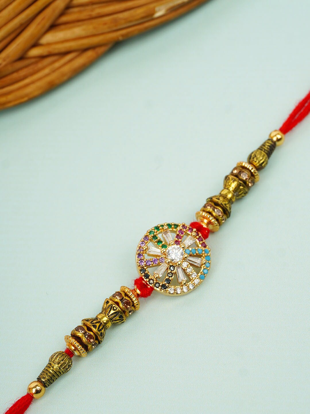 

Urmika Quirky Crystal Wheel Rakhi, Gold