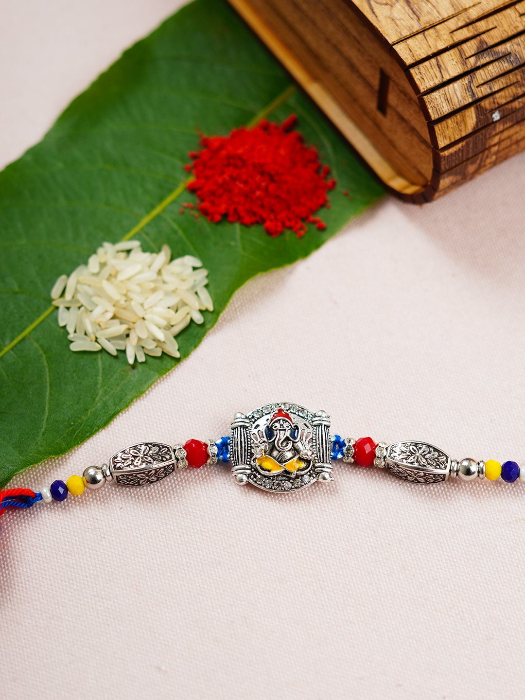 

Urmika Shri Ganesh Oxidized Religious Motif Thread Rakhi, Silver
