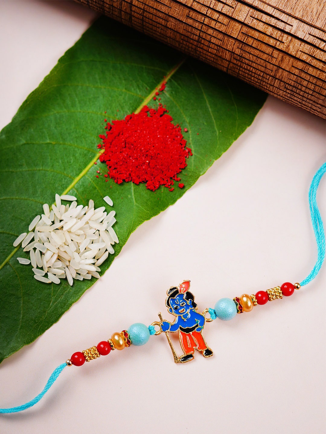

Urmika Beads Studded Bal Krishna Religious Rakhi, Blue
