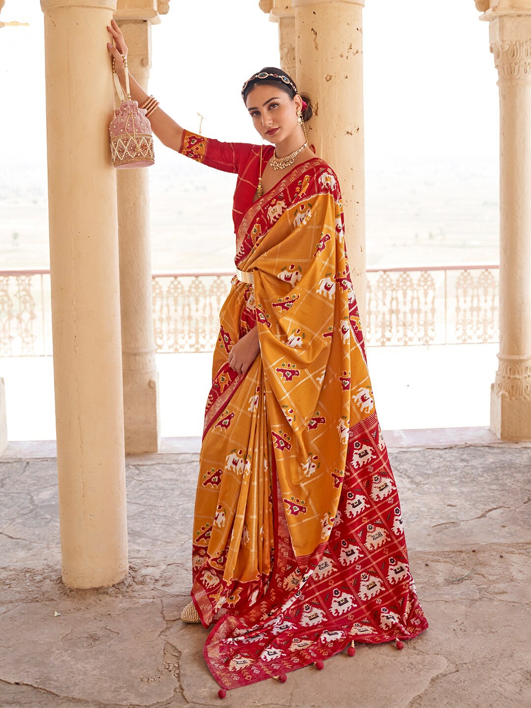 

Anouk Mustard & Red Ethnic Motifs Printed Zari Patola Saree