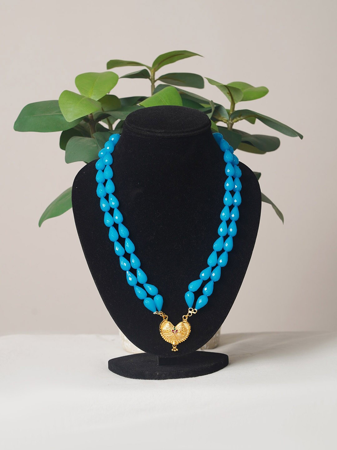 

Unnati Silks Oval Shape Beads Studded Layered Necklace With Pendent, Gold