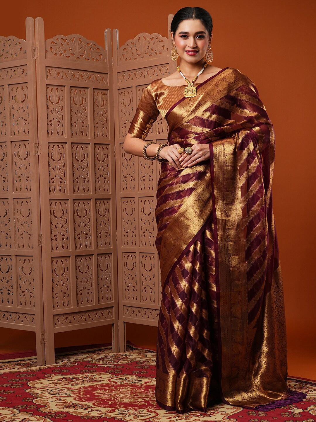 

Anouk Burgundy Ethnic Motif Woven Design Zari Organza Banarasi Saree