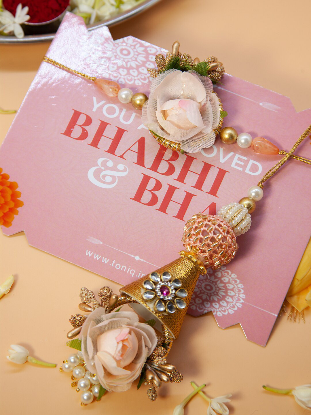 

Fida Set Of 2 Floral Pearl & Kundan Studded Bhaiya & Lumba Rakhi, Pink