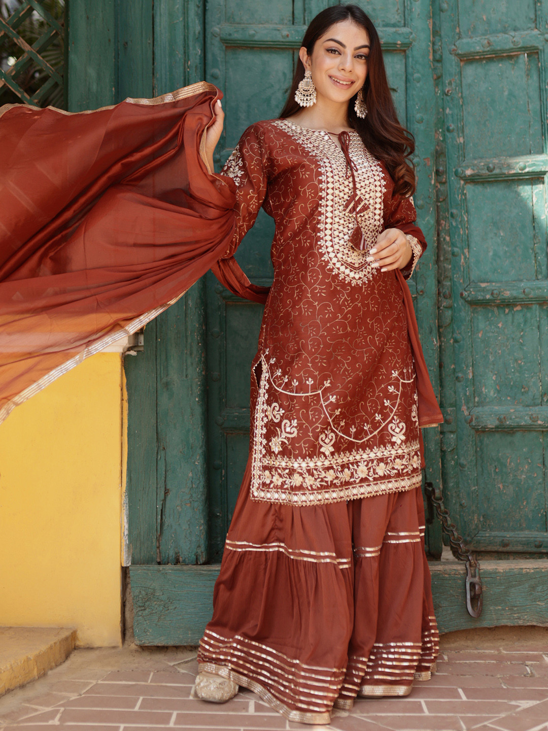 

Libas Rust & White Ethnic Motifs Mirror Work Embroidered Kurta With Sharara & Dupatta