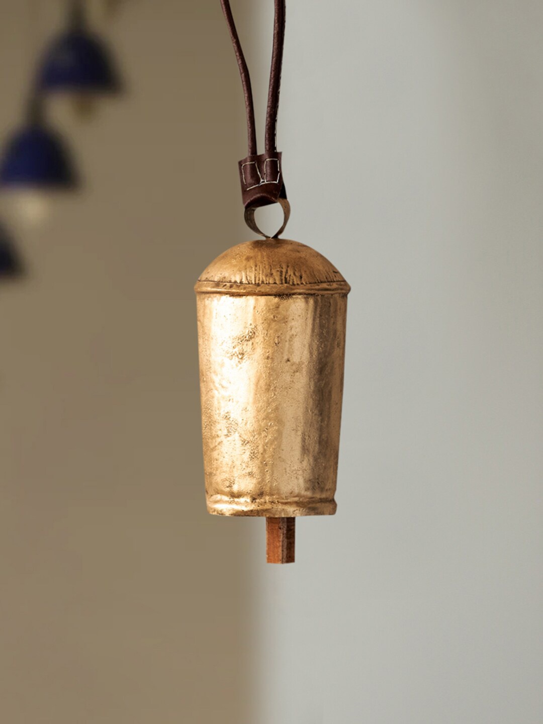 ExclusiveLane Gold Toned Metal Bell Windchimes With Leather Strap