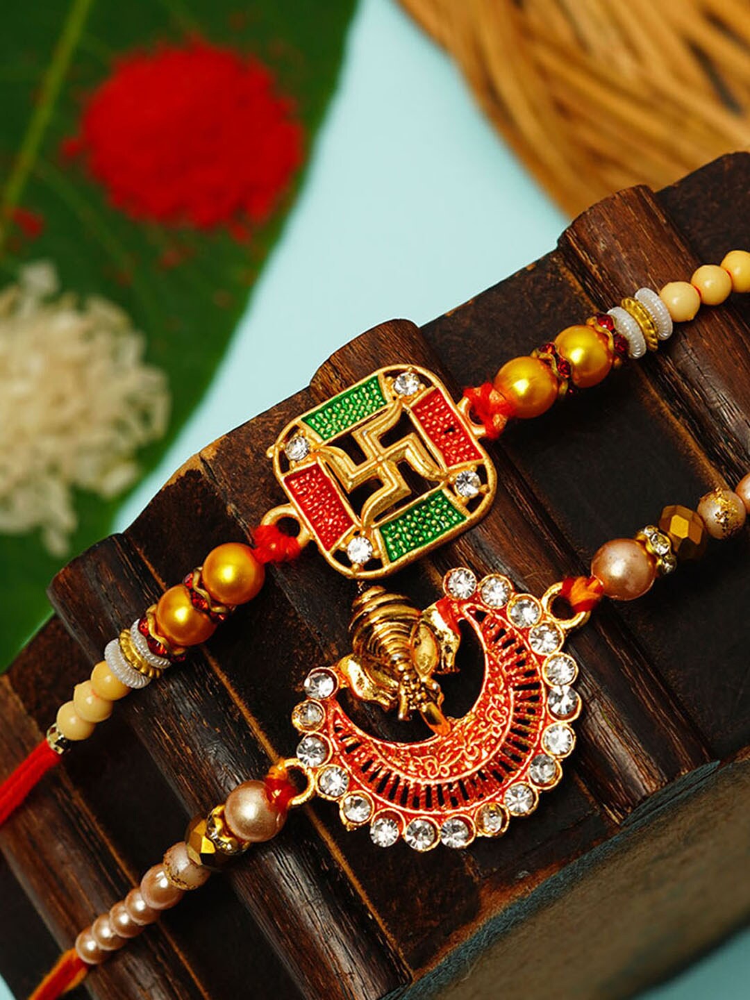 

Urmika Set Of 3 Swastika & Shri Ganesh Thread Rakhi, Red