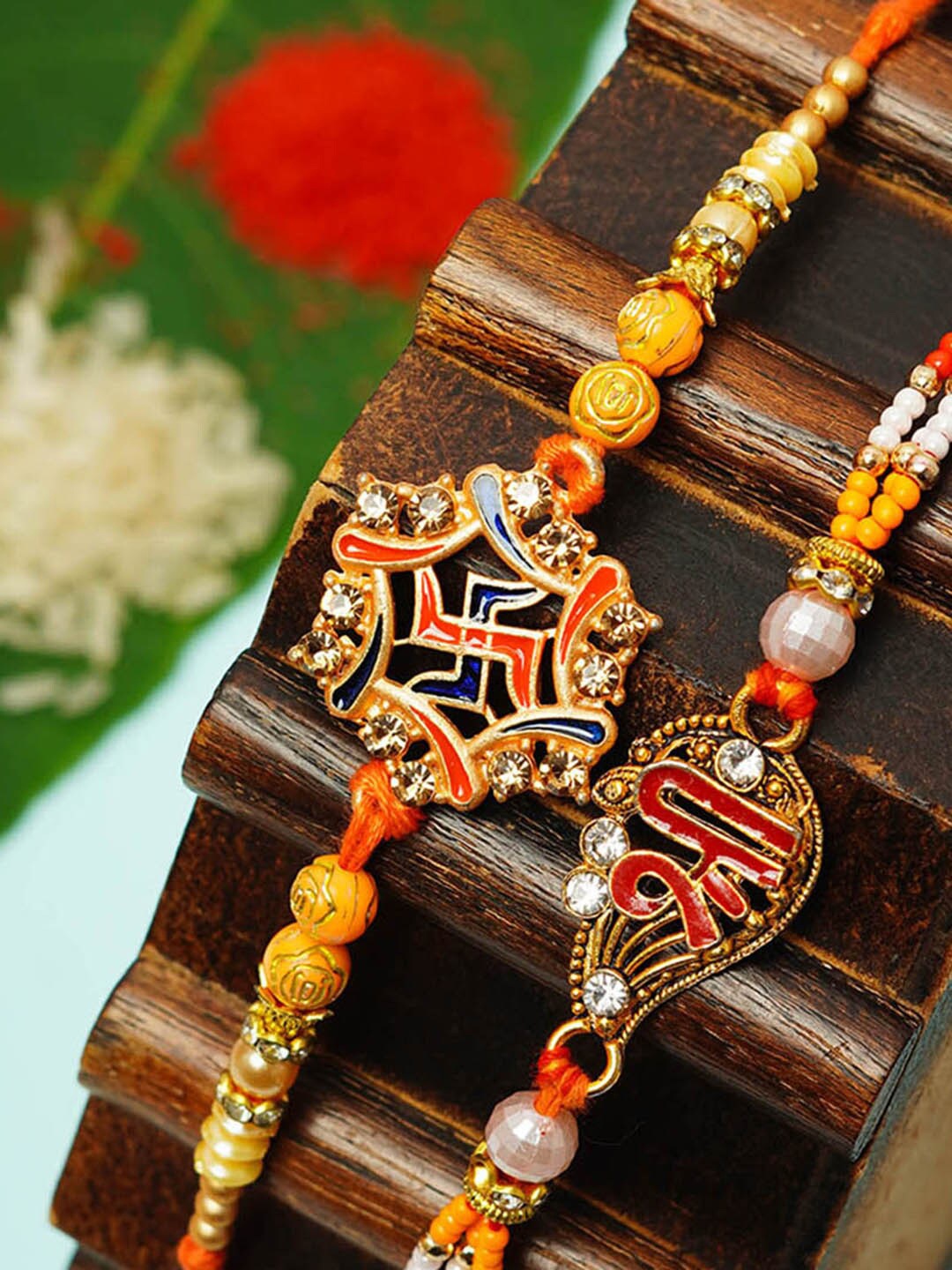 

Urmika Set Of 2 Swastika & Shri Religious Rakhi, Orange