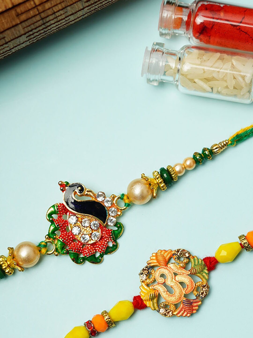

Urmika Set Of 2 Om & Peacock Rakhi, Gold