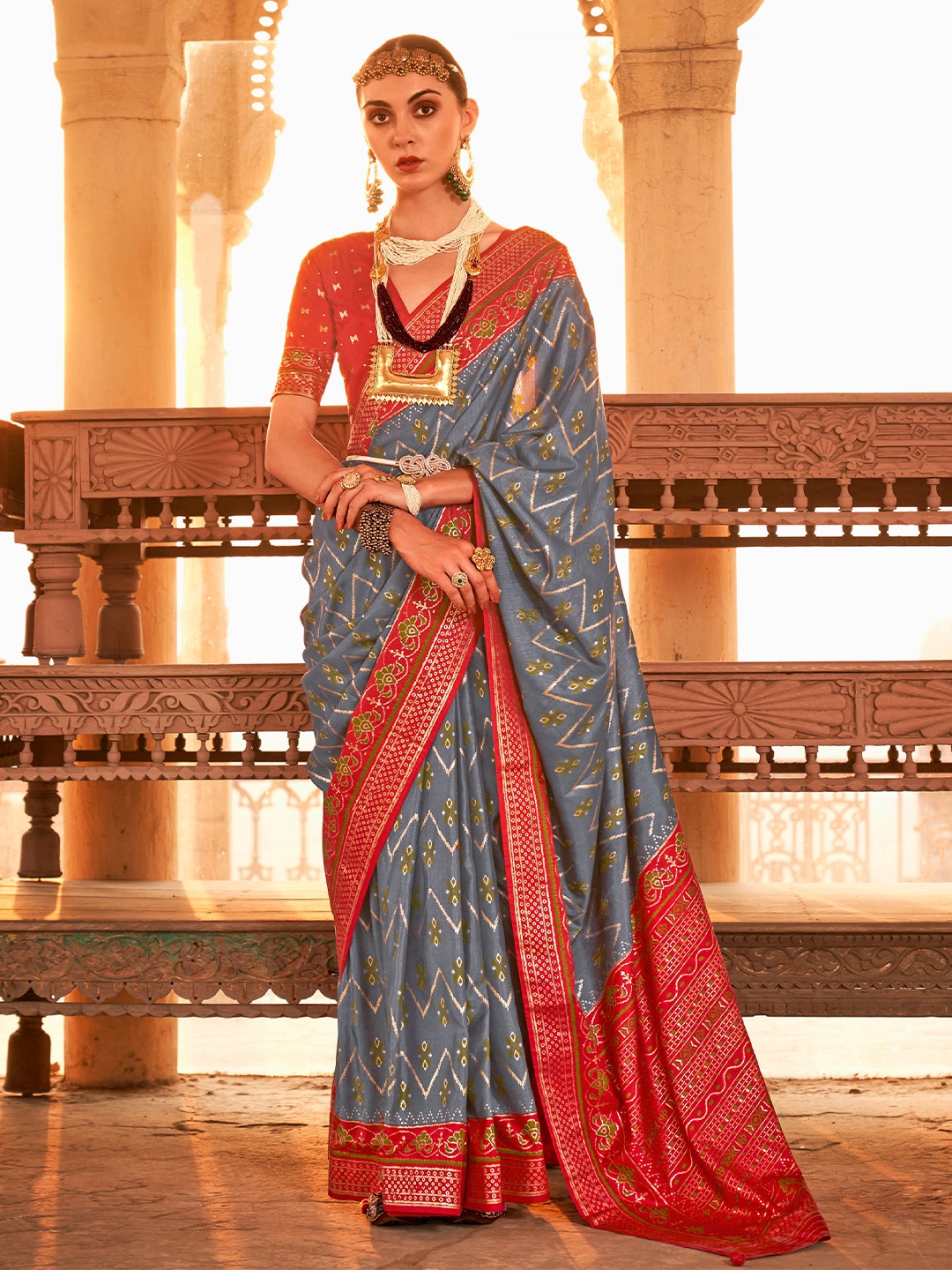 

Mitera Grey & Red Ethnic Motifs Woven Design Zari Saree