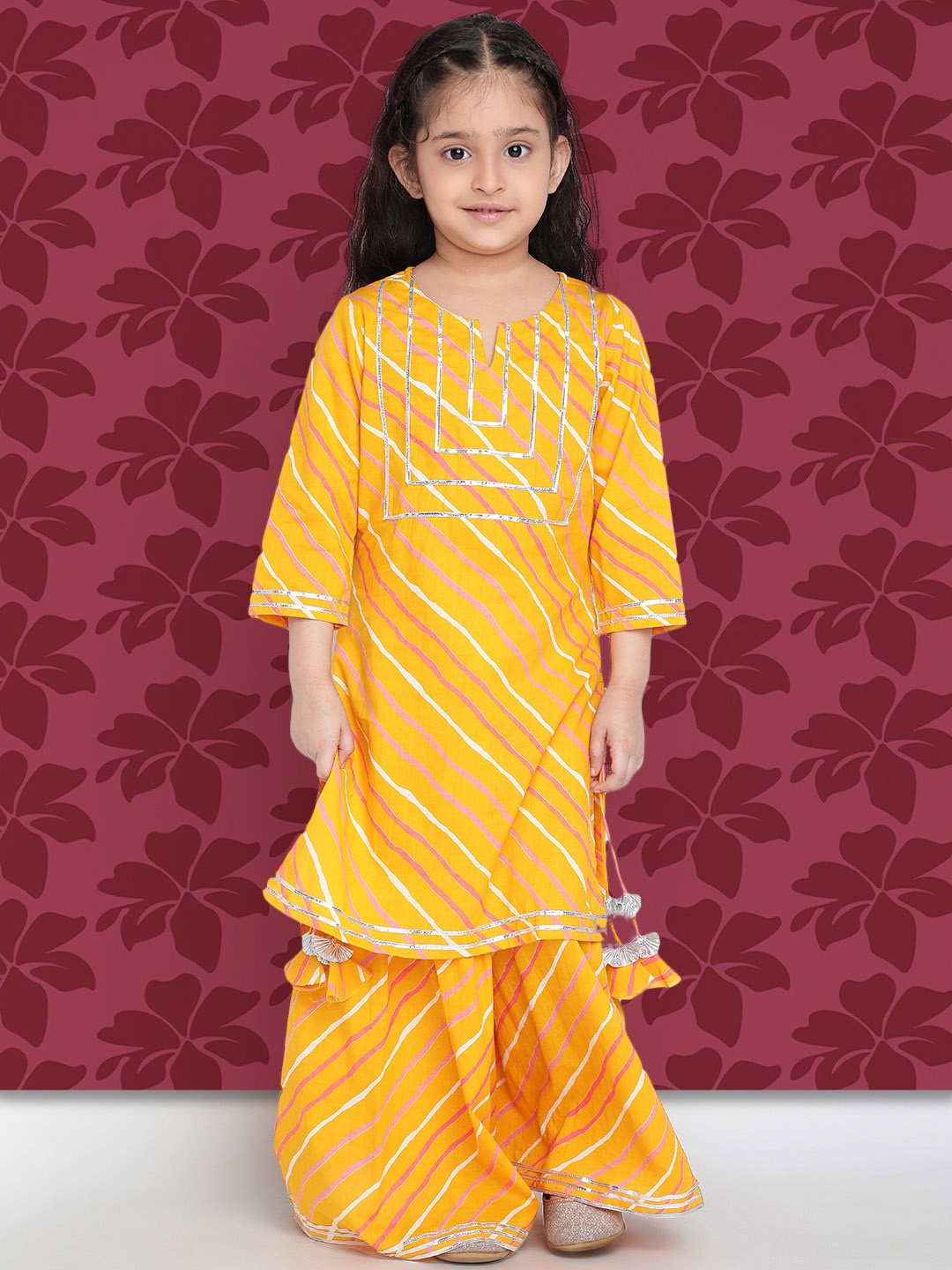 

Indo Era Girls Mustard Yellow Leheriya Printed Regular Gotta Patti Kurta With Sharara