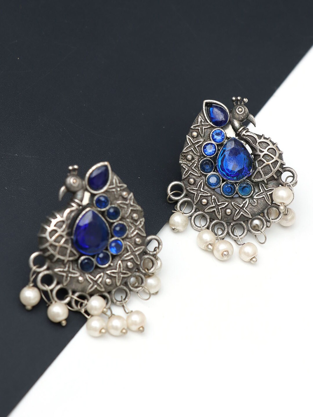 

Ozanoo Silver Plated Peacock Shaped Chandbali Earrings
