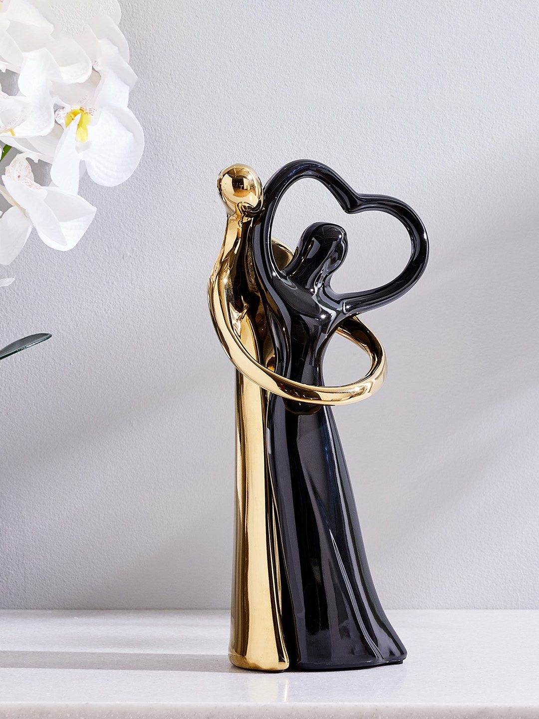 

Home Centre Black & Golden Ceramic Couple Showpiece