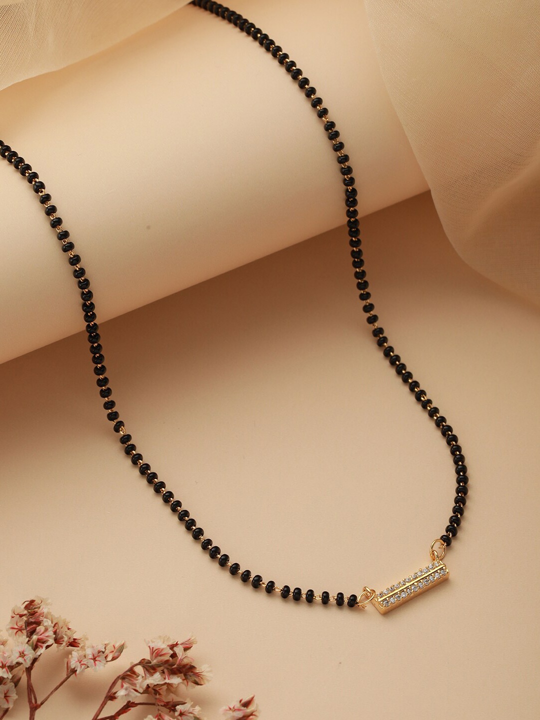 

Jazz and Sizzle Gold-Plated American Diamond Stone-Studded & Black Beaded Mangalsutra